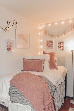 a bed with pink and white pillows on top of it