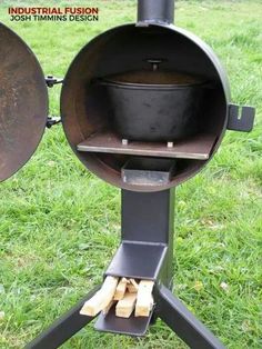 an outdoor wood burning stove with two pans on it's stand in the grass