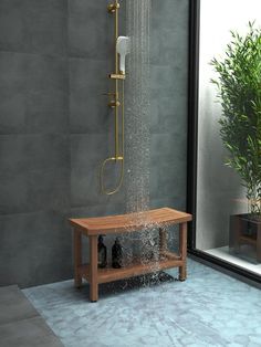 a shower head with water coming from it and a wooden bench in front of it