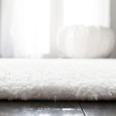 a close up view of a white rug on the floor