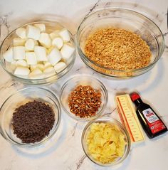 bowls filled with different types of food sitting on a counter next to a measuring cup