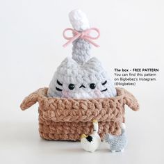 there is a crocheted basket with two stuffed animals in it