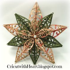 an ornament made out of metal and paper