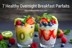 three glasses filled with fruit and yogurt on top of a table