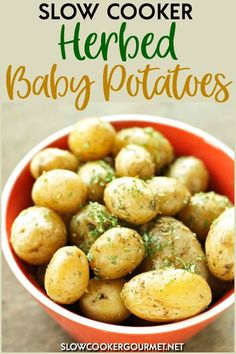 a bowl full of baby potatoes with the words slow cooker herbed baby potatoes