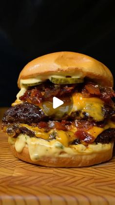 a bacon cheeseburger on a wooden table