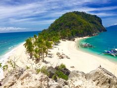 boats are parked on the beach next to an island