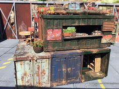 an old, rusted out kitchen with potted plants on the top and outside