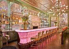 the bar is decorated in pink and gold