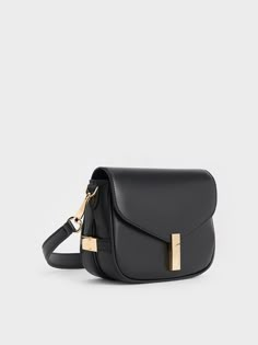 Sleek and sophisticated, this Aurelia saddle bag is a modern classic that will never go out of style. Featuring a timeless silhouette and a versatile black finish, this polished carrier stands out with its distinctive gold-tone hardware. A chic turn-lock closure -- taking the form of a narrow vertical bar -- is the striking centrepiece of this design. This bag also comes with an adjustable strap that you can clip on easily to transform it into a handy crossbody bag. Small Black Leather Purse, Black Bag Outfit, Black Sling Bag, Vertical Bar, Crossbody Bag Black, Black Leather Purse, Charles Keith, Saddle Bag, My Wish List