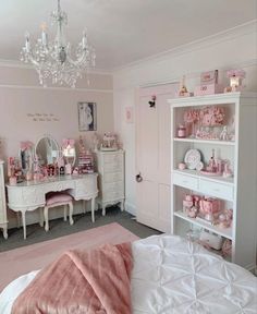 a bedroom with pink walls and white furniture