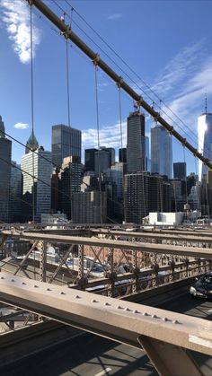 the city skyline is seen from across the bridge