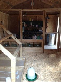 the inside of a small wooden house with stairs