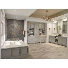 a large bathroom with gray cabinets and white counter tops, along with a chandelier hanging from the ceiling