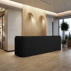 an empty reception room with large windows and wooden flooring, along with potted plants