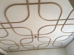 the ceiling is decorated with wooden pipes and wires