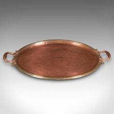 an oval metal tray with handles