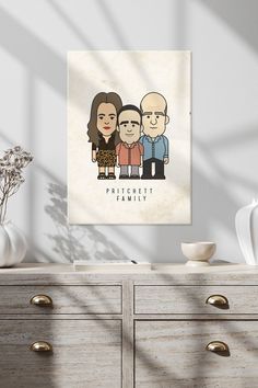 a family portrait hanging on the wall above a dresser