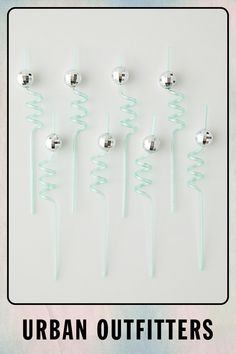 there are six different types of hair pins on the same stick and one is green