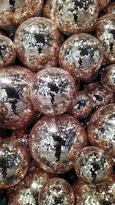 many shiny disco balls are stacked on top of each other