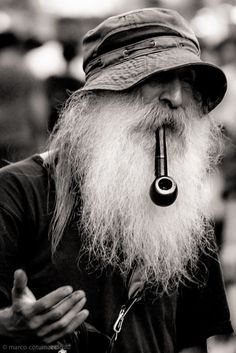 an old man with a pipe in his mouth