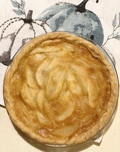 an apple pie sitting on top of a table