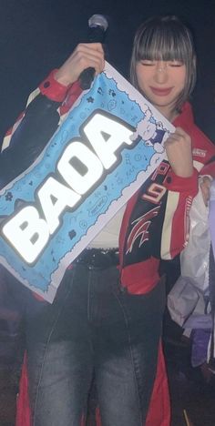 a woman holding up a sign with the word baoba on it