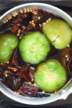 an image of some food in a pot on the stove top with oil and spices