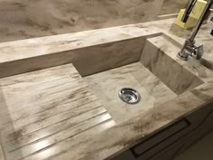 a bathroom sink sitting under a faucet next to a mirror