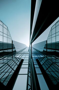 some very tall buildings that are next to each other in the day time lapse