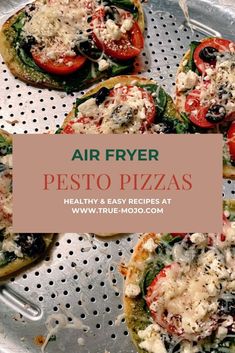 four pizzas sitting on top of a pan covered in cheese and toppings with the words air fryer pesto pizzas