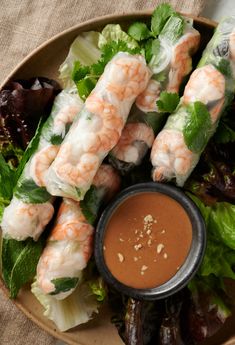 shrimp and lettuce with dipping sauce in a bowl