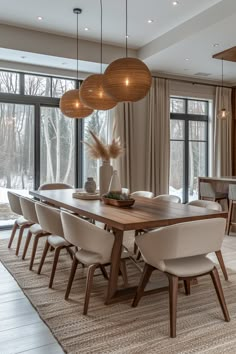 the dining room table is surrounded by beige chairs