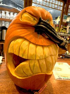 a carved pumpkin with its mouth open on a table