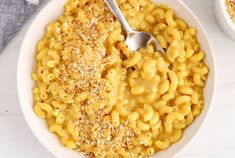 a bowl of macaroni and cheese with a spoon