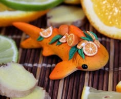 an orange figurine sitting on top of sliced lemons