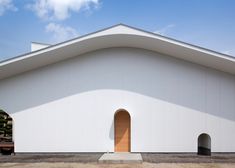 a large white building with a wooden door