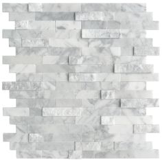 a white marble tile wall with grey and white tiles on the bottom, in rows