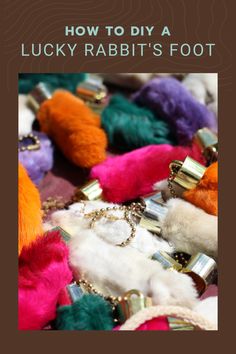 the cover of how to diy a lucky rabbit's foot, with lots of colorful pom poms