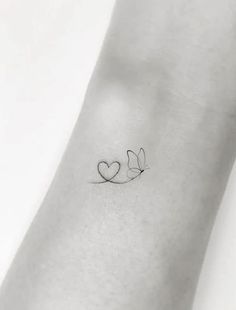 a small tattoo with two hearts on the wrist and one heart in the other hand