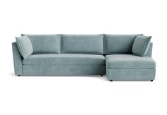 a blue sectional couch with pillows on the top and bottom, in front of a white background