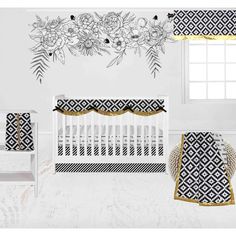 a baby crib bedding set with black and white floral designs on the wall