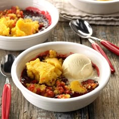 two bowls filled with food and ice cream on top of a wooden table next to utensils