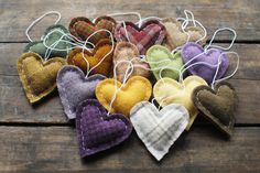 several heart shaped ornaments sitting on top of a wooden table next to twine strings