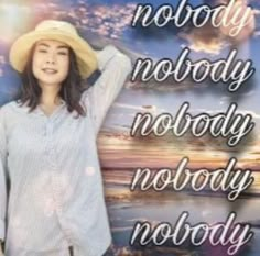 a woman wearing a hat and standing in front of a sign that says nobody nobody