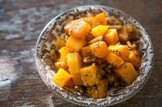 a bowl filled with food sitting on top of a wooden table