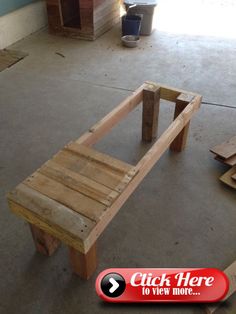 a wooden bench made out of pallets in a garage with other pieces of wood