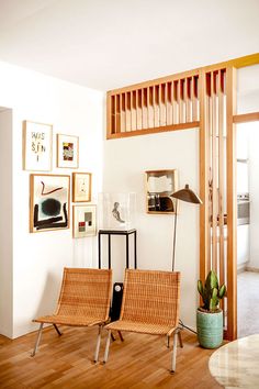 a living room filled with furniture and pictures on the wall next to a wooden floor