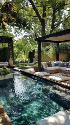 an outdoor living area with a pool and couches