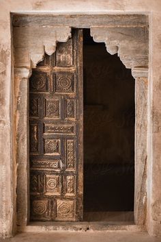 an old wooden door with intricate carvings on the outside and inside by jovan for stocks